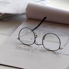 Glasses on the paper notebook - concept of education